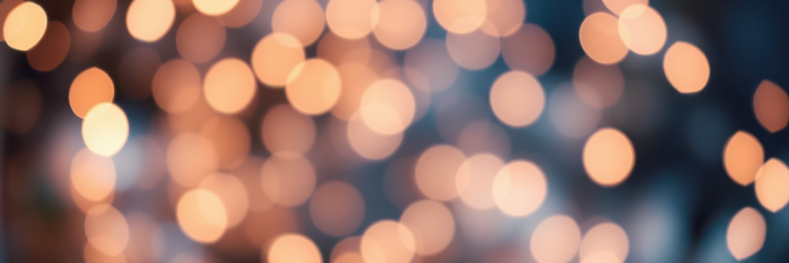 Soft golden bokeh lights create a warm and inviting atmosphere in a cozy indoor setting during the evening